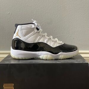 Air Jordan 11 Gratitude Black and White Sneakers with Gold Accent